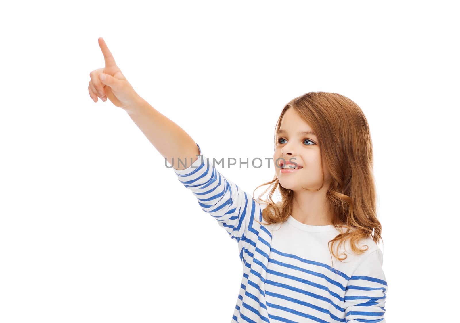 education, school and virtual screen concept - cute little girl pointing in the air or virtual screen