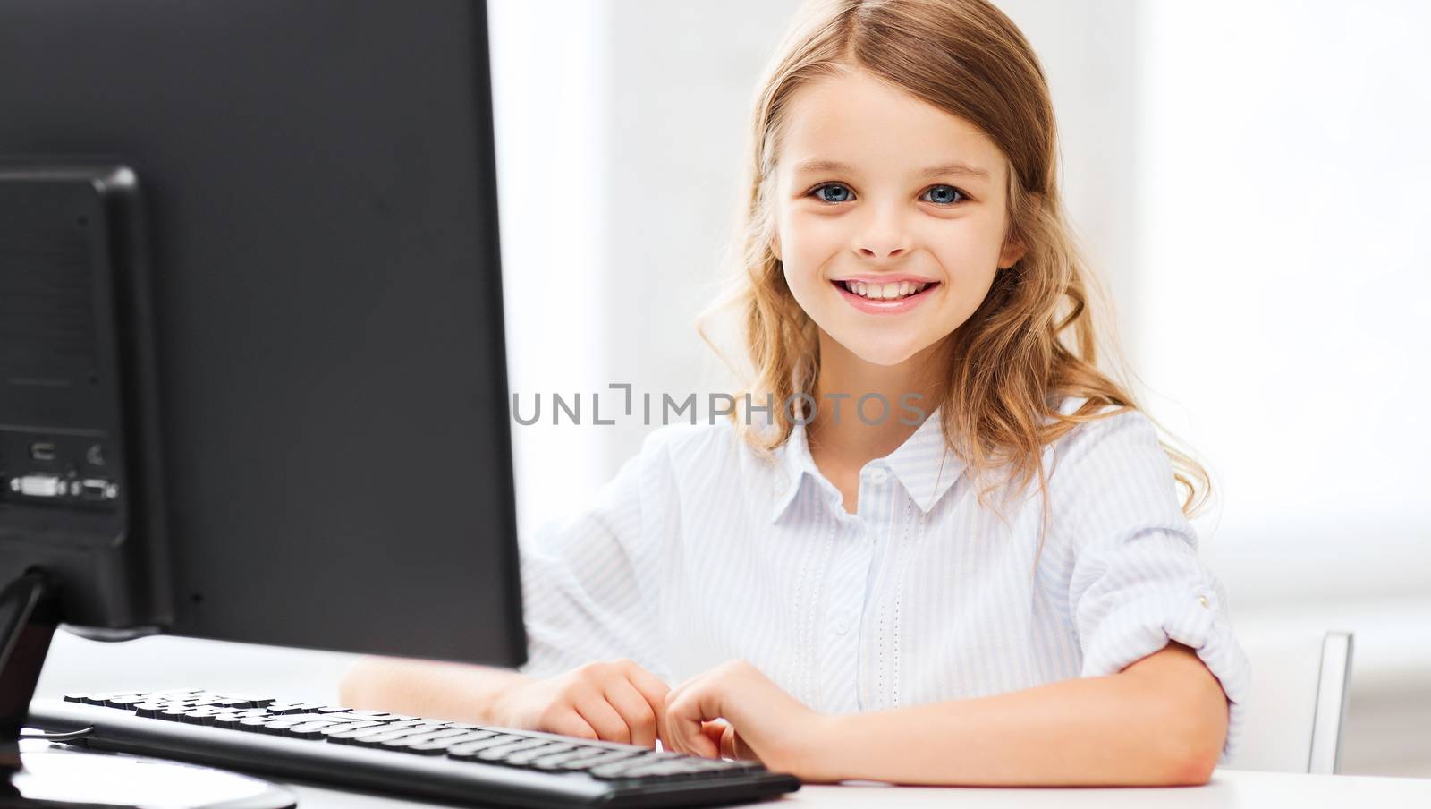 education, school, technology and internet concept - little student girl with computer at school