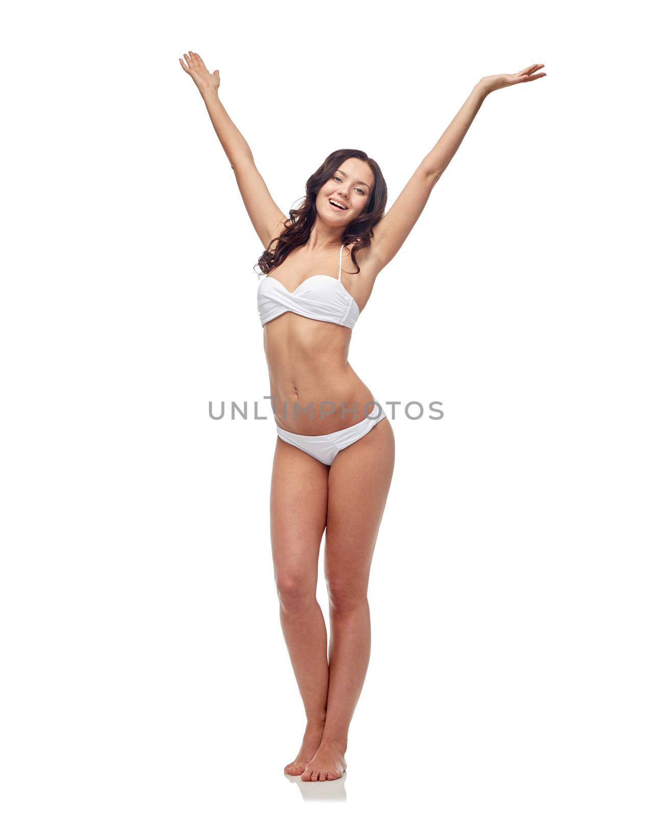 happy young woman in white bikini swimsuit dancing by dolgachov