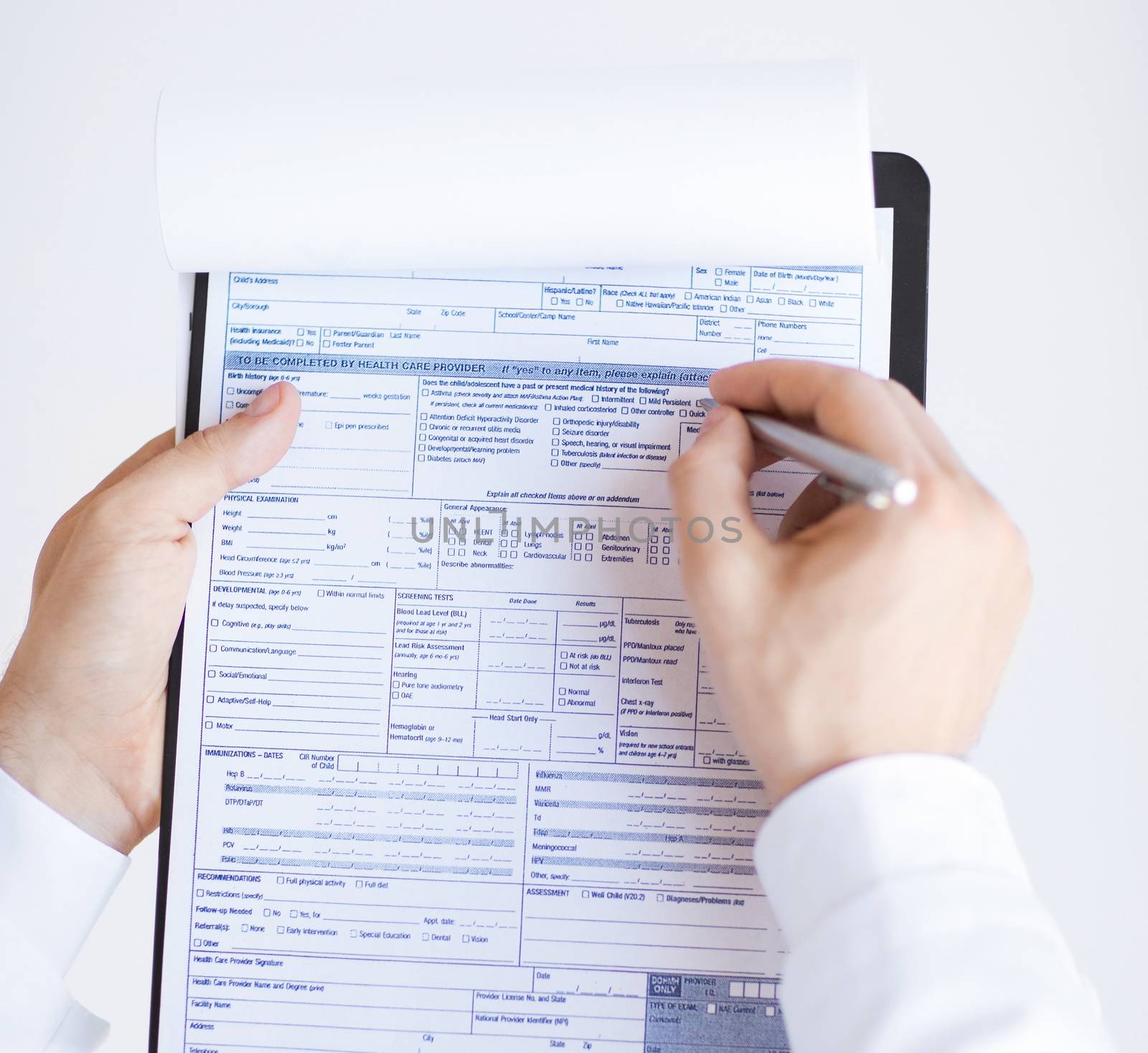 close up of male doctor holding prescription paper in hand