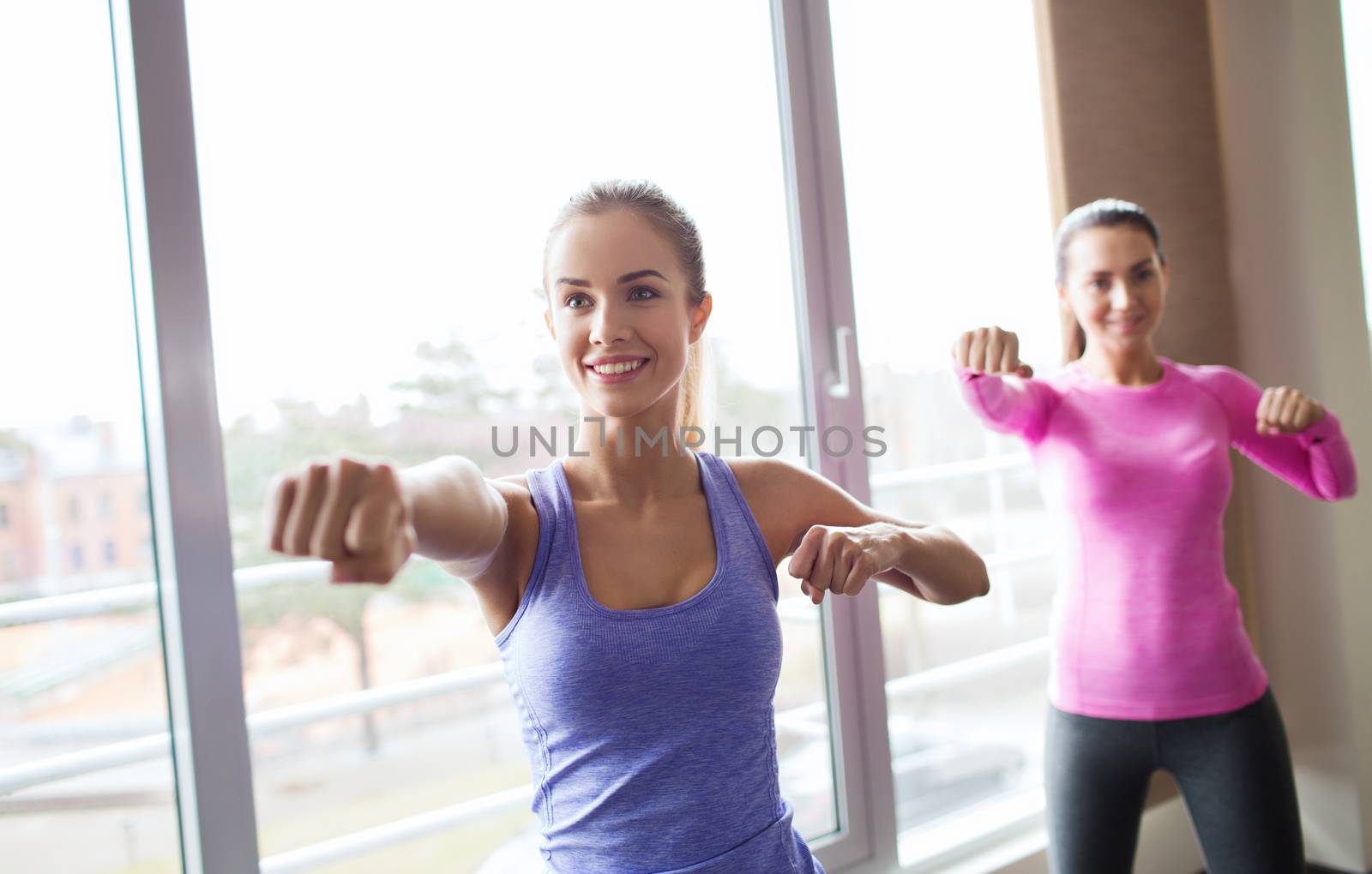group of happy women working out in gym by dolgachov