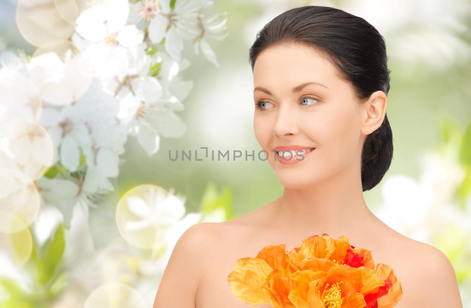 beauty, people, holidays and health concept - beautiful young woman with flowers over green blooming garden background