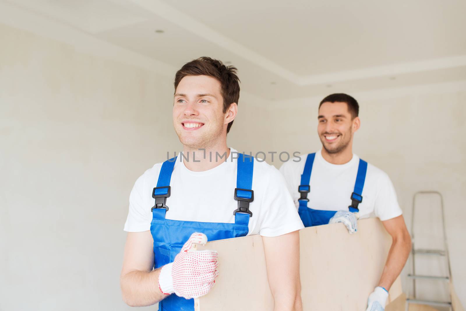 group of builders with wooden boards by dolgachov