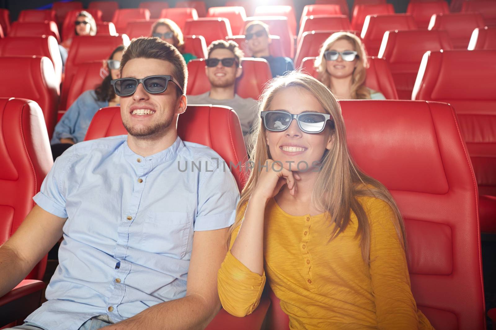 cinema, entertainment and people concept - happy friends with 3d glasses watching movie in theater