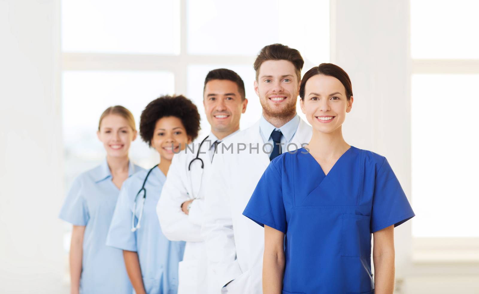 hospital, profession, people and medicine concept - group of happy doctors at hospital