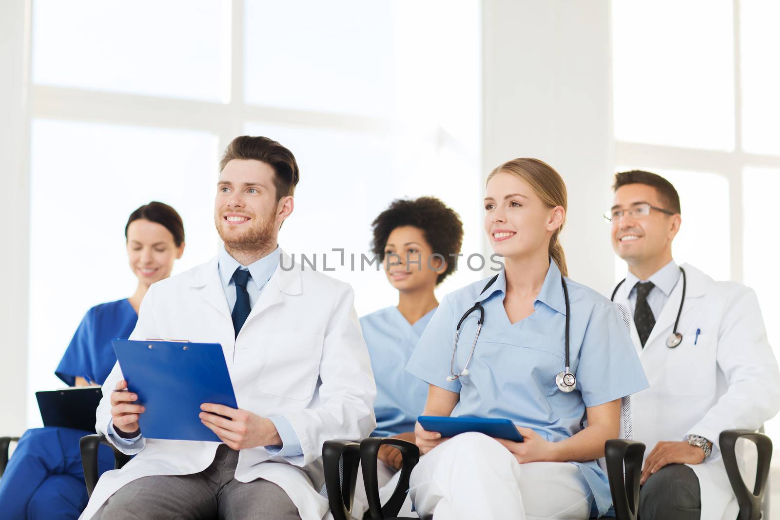 group of happy doctors on seminar at hospital by dolgachov