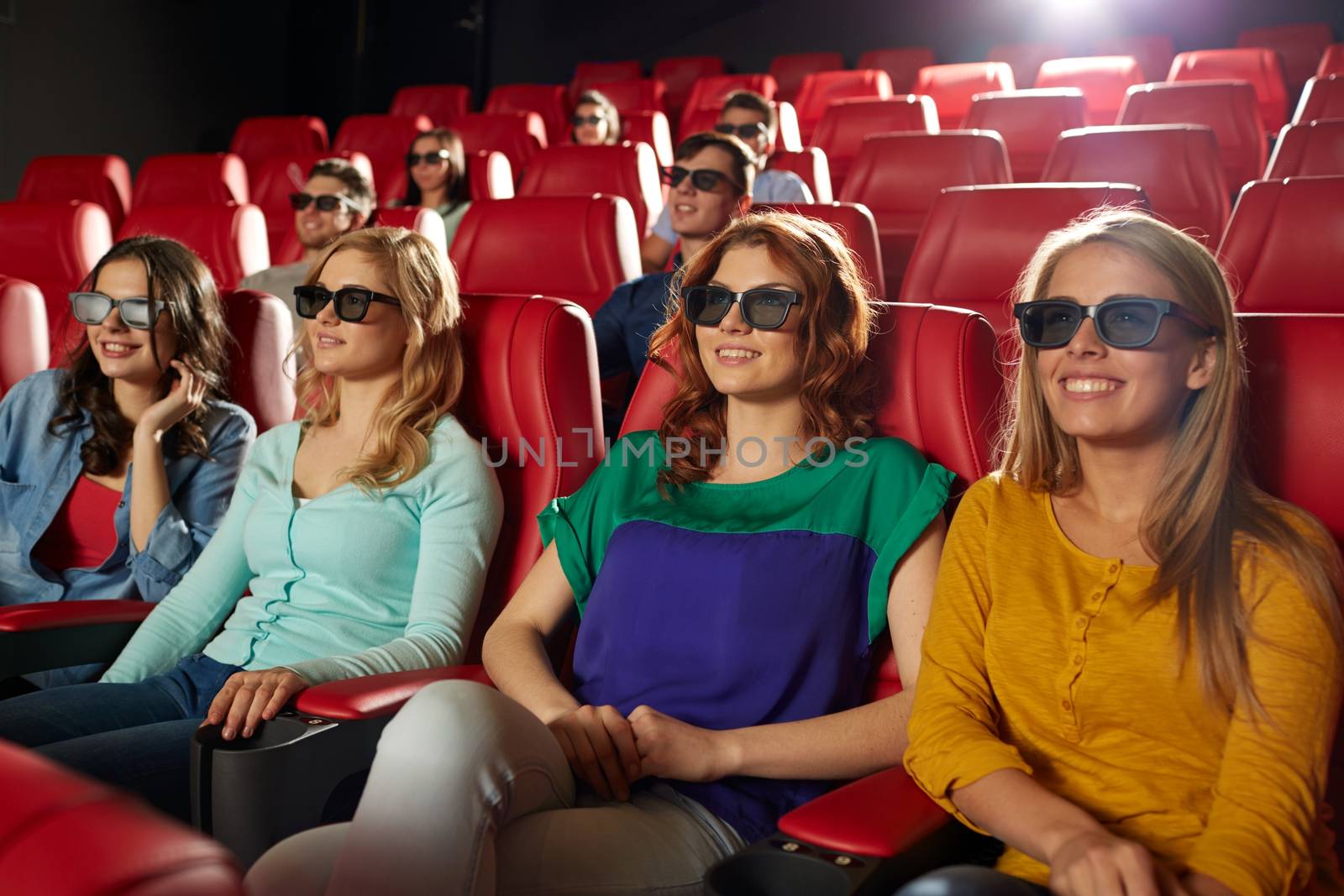 happy friends watching movie in 3d theater by dolgachov