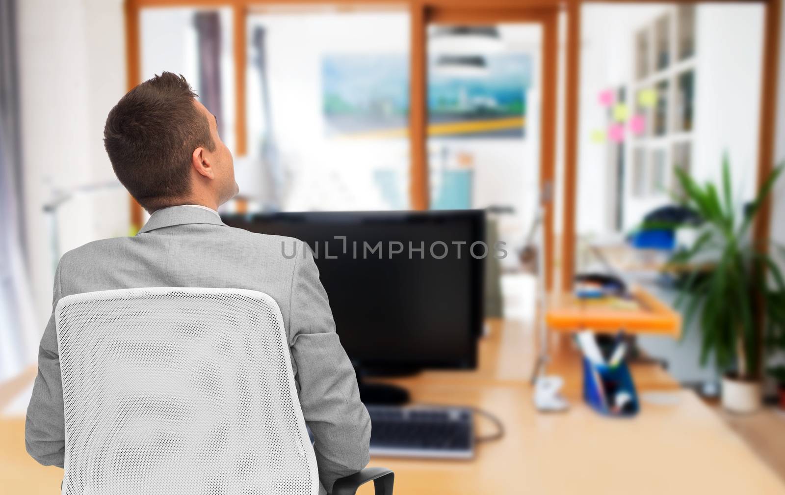 business, people, furniture, rear view and office concept - businessman sitting in chair from back over office room background