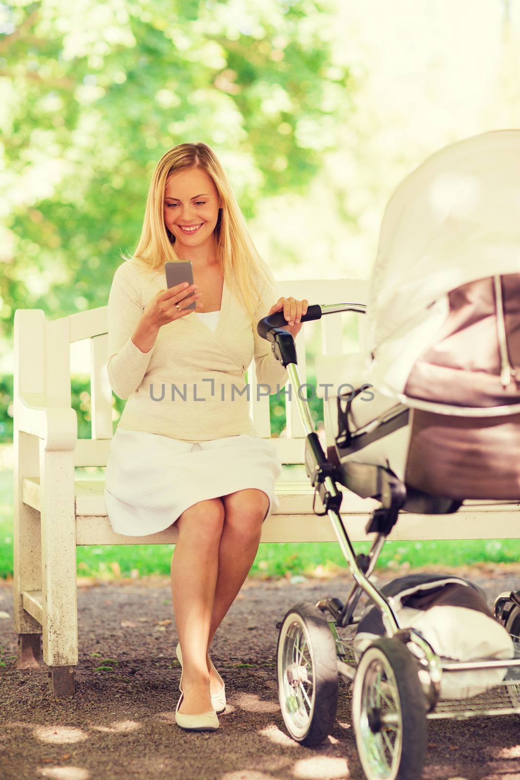 family, parenthood, technology and people concept - happy mother with with smartphone and baby stroller in park