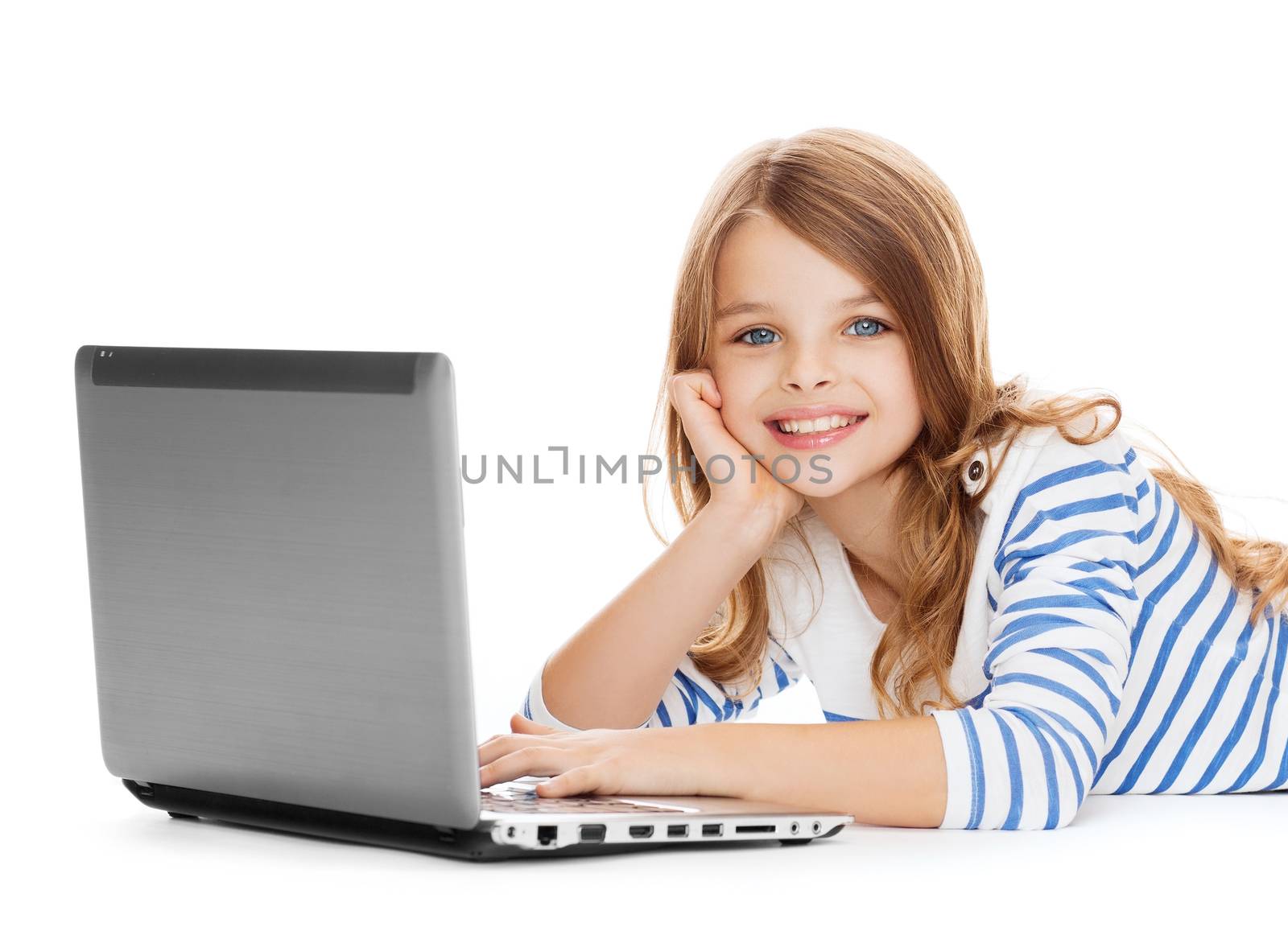 education, technology and internet concept - smiling little student girl with laptop computer lying on the floor