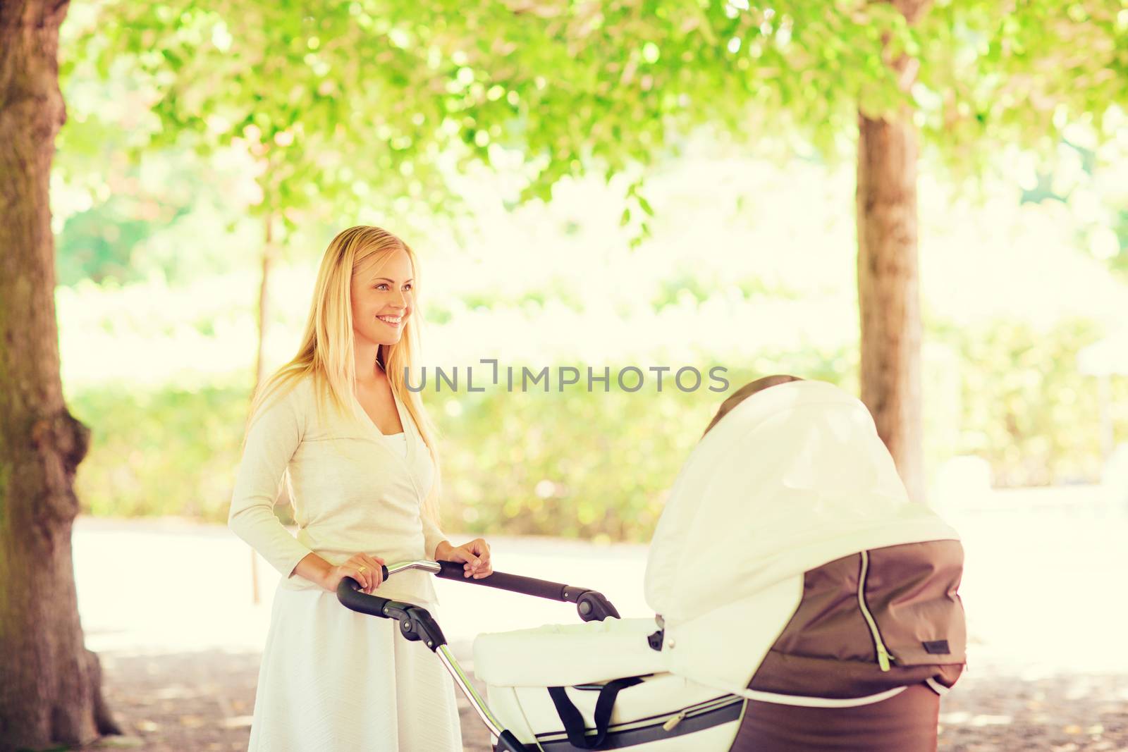 family, child and parenthood concept - happy mother with stroller in park