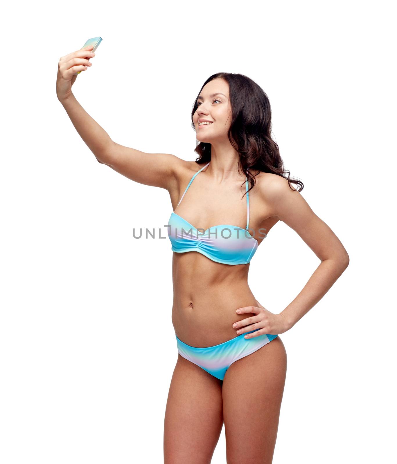 people, technology, summer and beach concept - happy young woman in bikini swimsuit taking selfie with smatphone