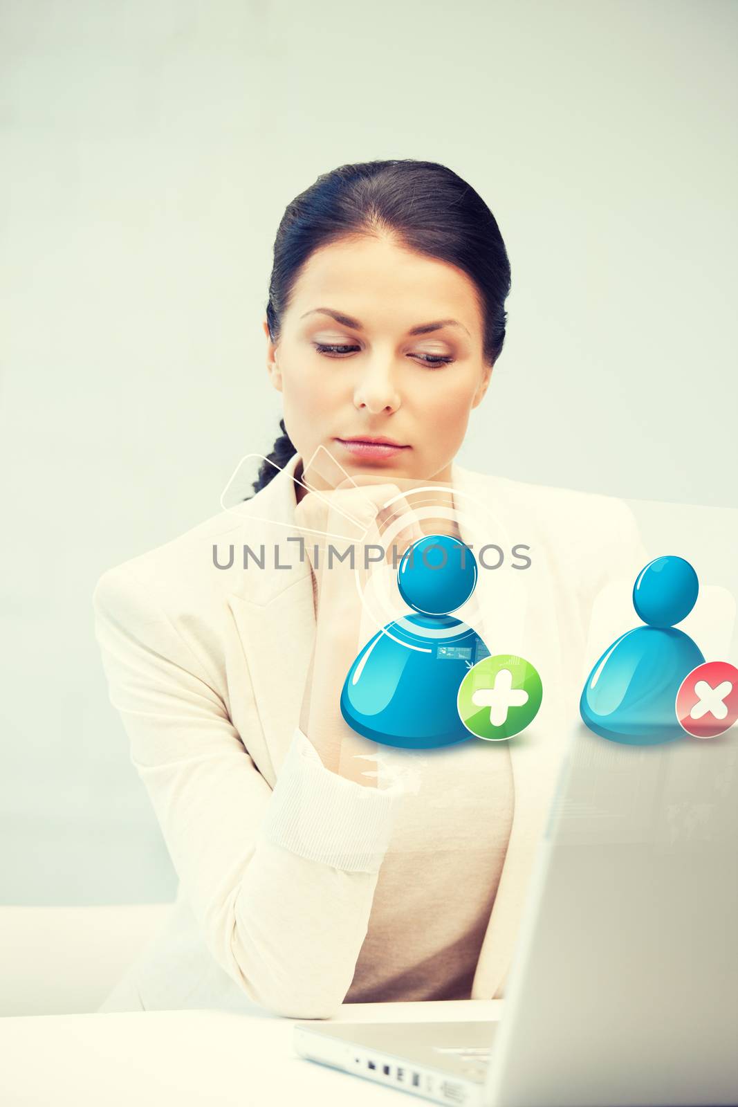 businesswoman looking at laptop with contact icon