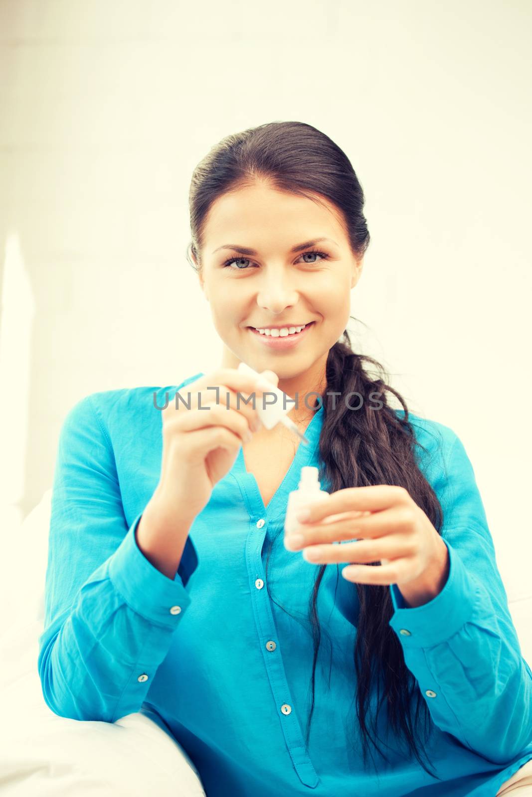.picture of beautiful woman polishing her nails