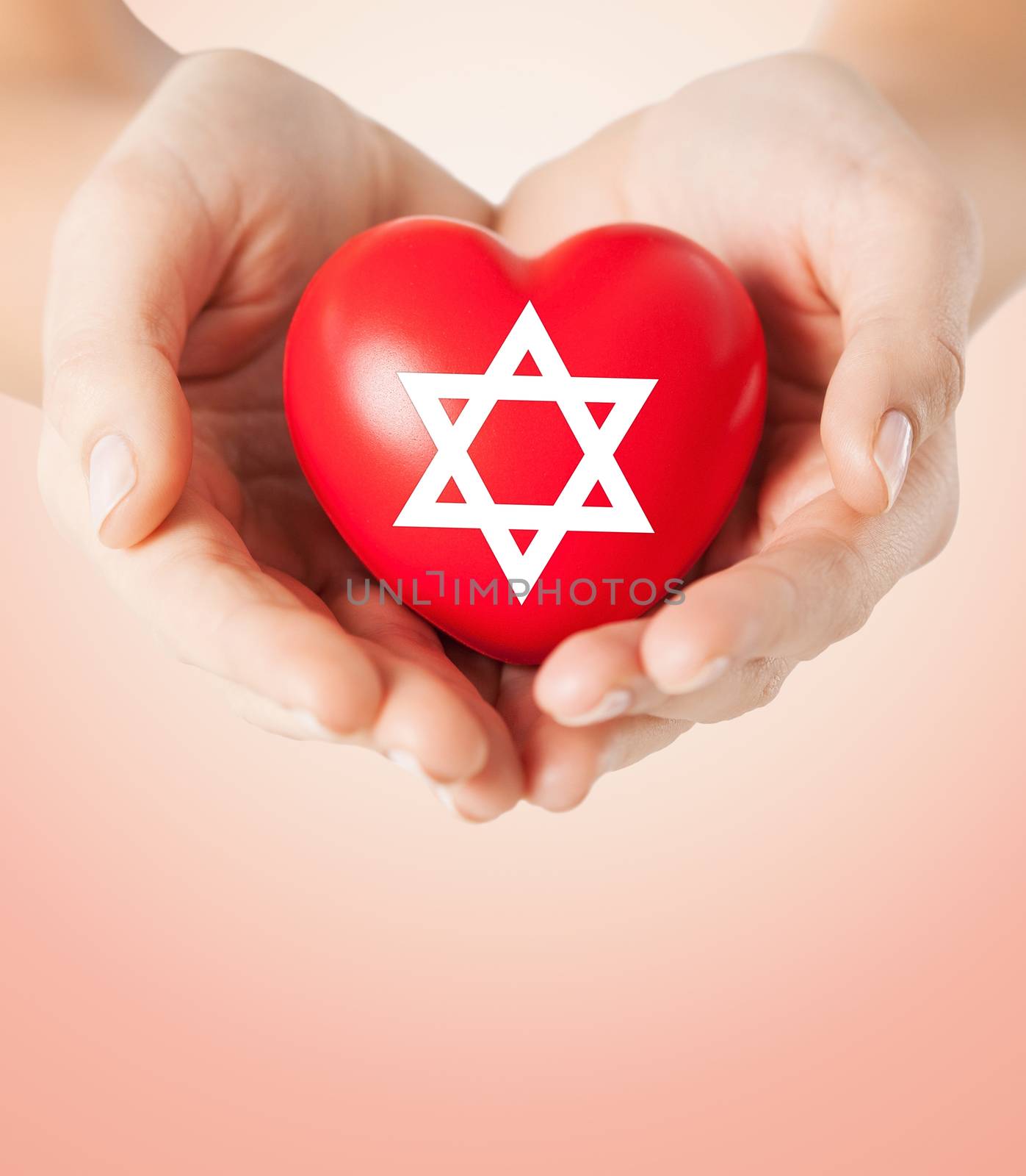 close up of hands holding heart with jewish star by dolgachov