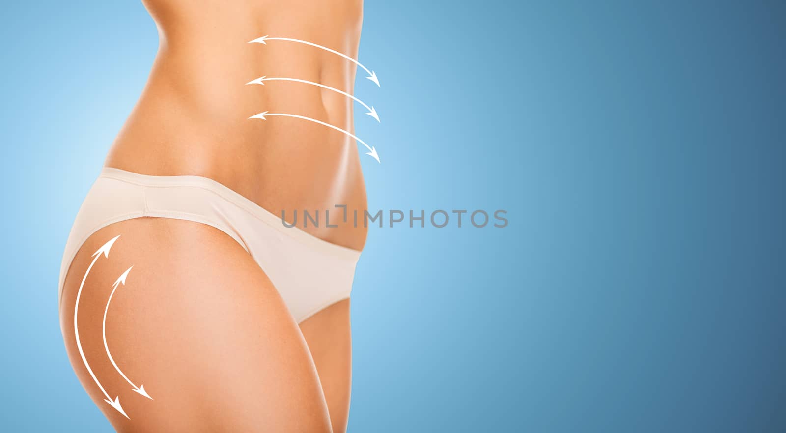 people, health, body care and beauty concept - close up of slim woman tummy and hips in underwear over blue background