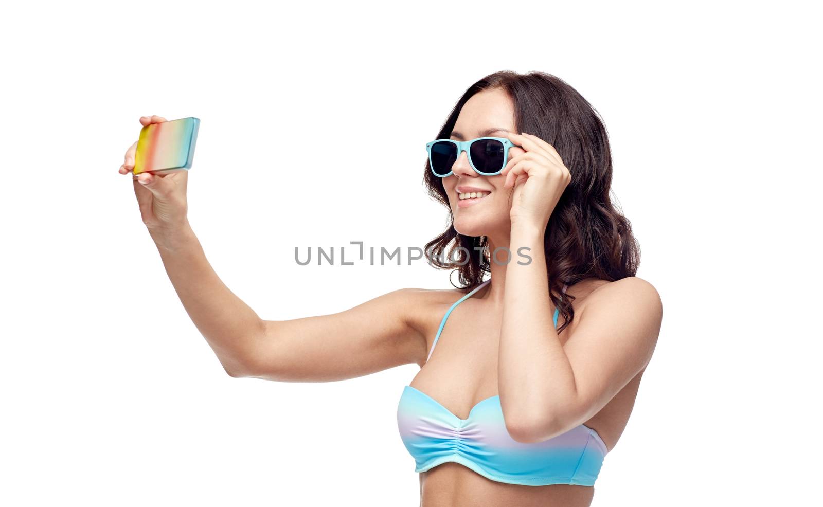 woman in swimsuit taking selfie with smatphone by dolgachov