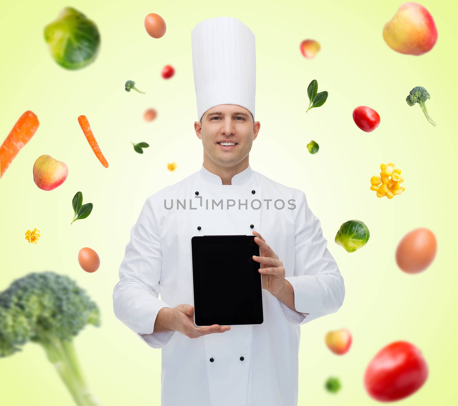 happy male chef cook showing with tablet pc by dolgachov