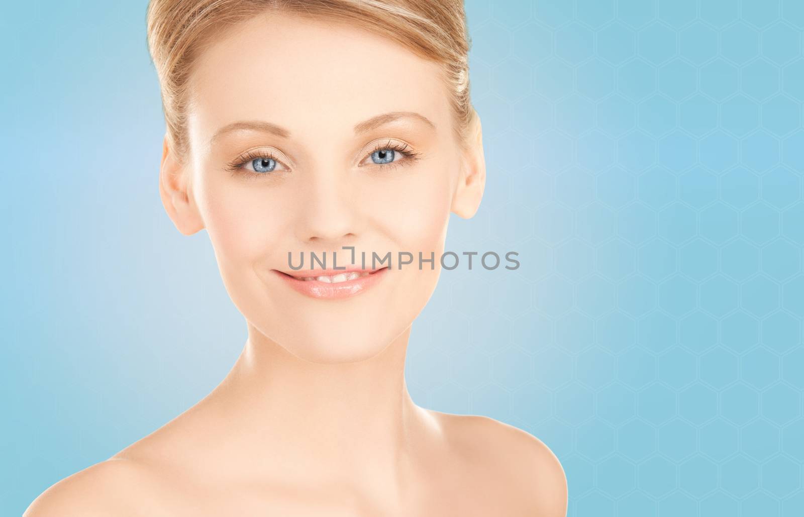 beautiful young woman face over blue background by dolgachov