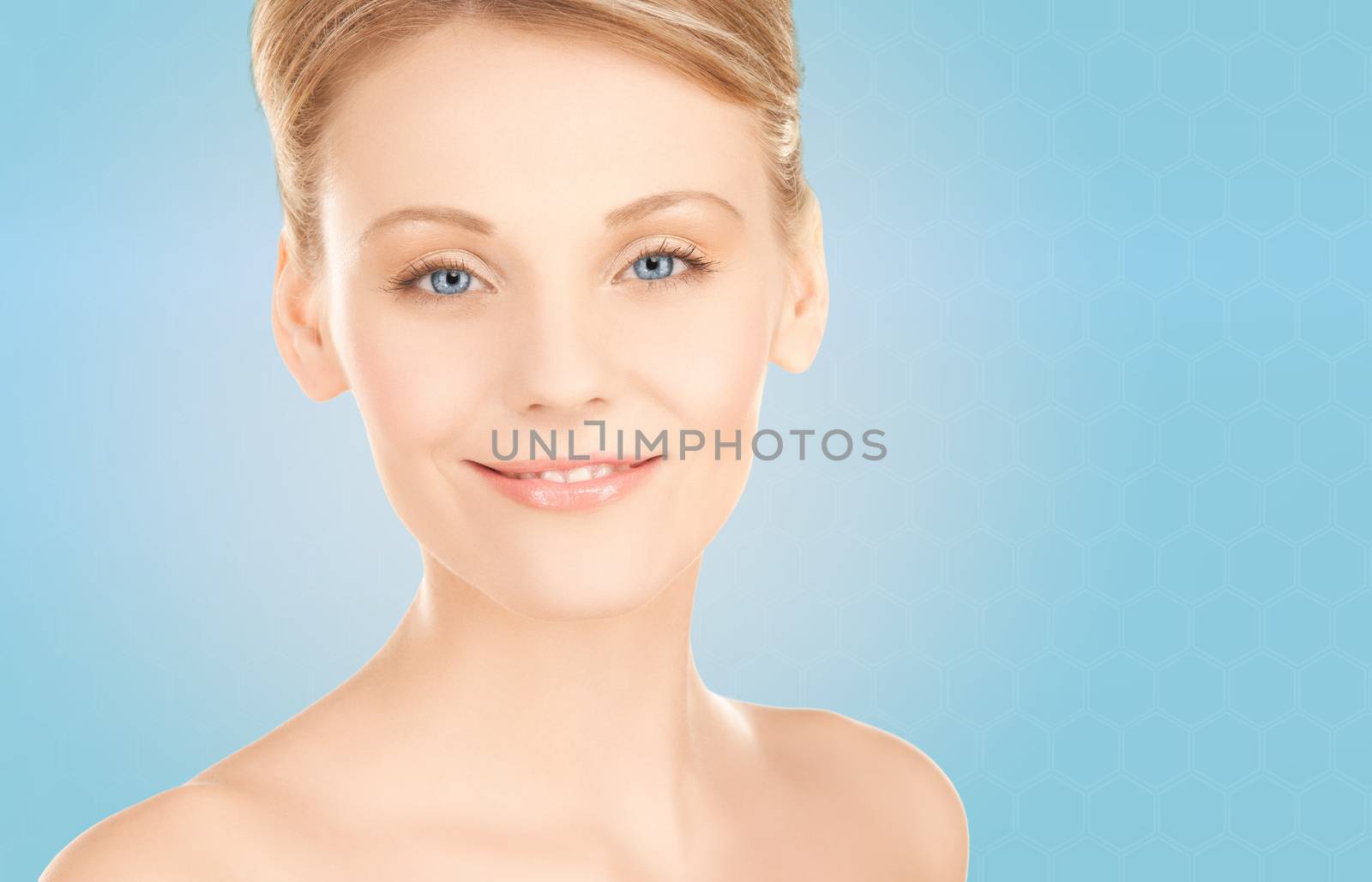 beauty, people and health concept - beautiful young woman face over blue background