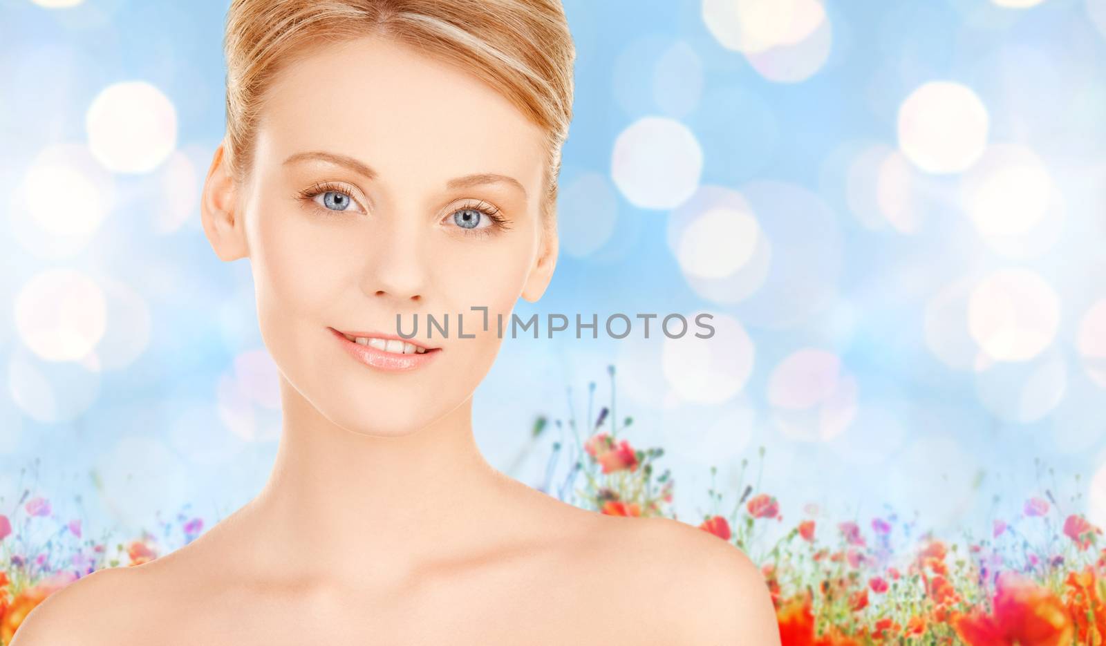 beautiful young woman face over blue background by dolgachov