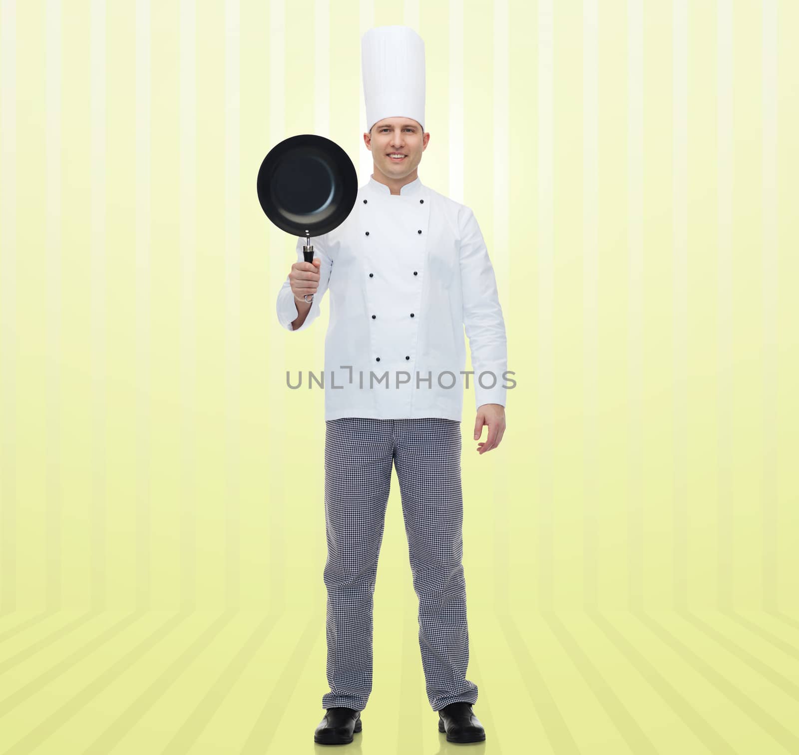happy male chef cook holding frying pan by dolgachov
