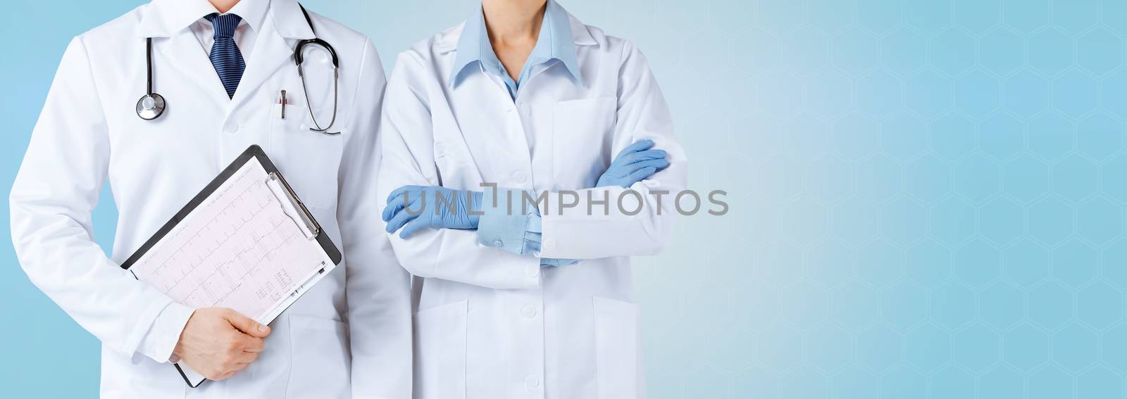medicine, people, cardiology and health care concept - close up of nurse and male doctor holding cardiogram