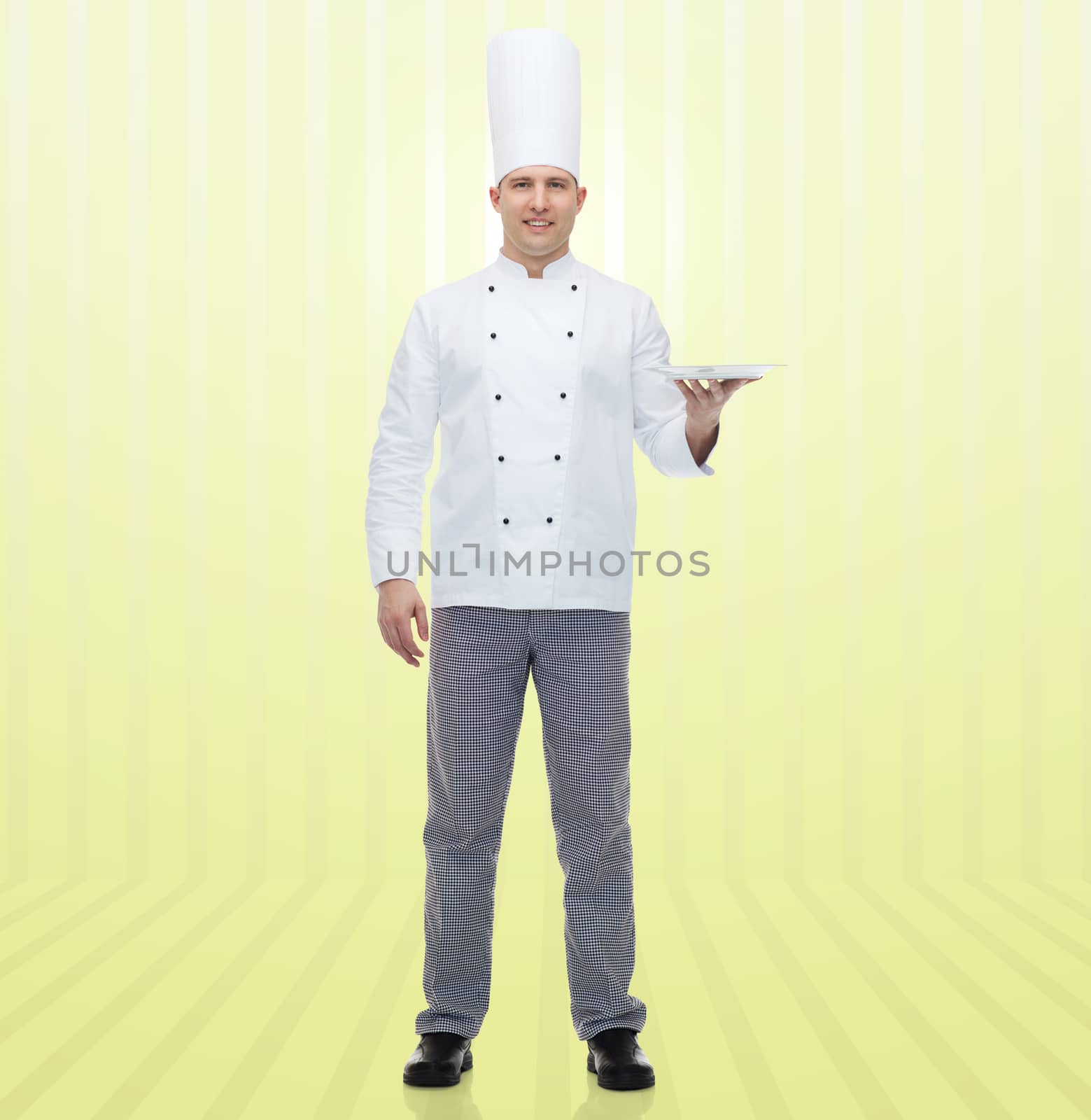 happy male chef cook showing empty plate by dolgachov