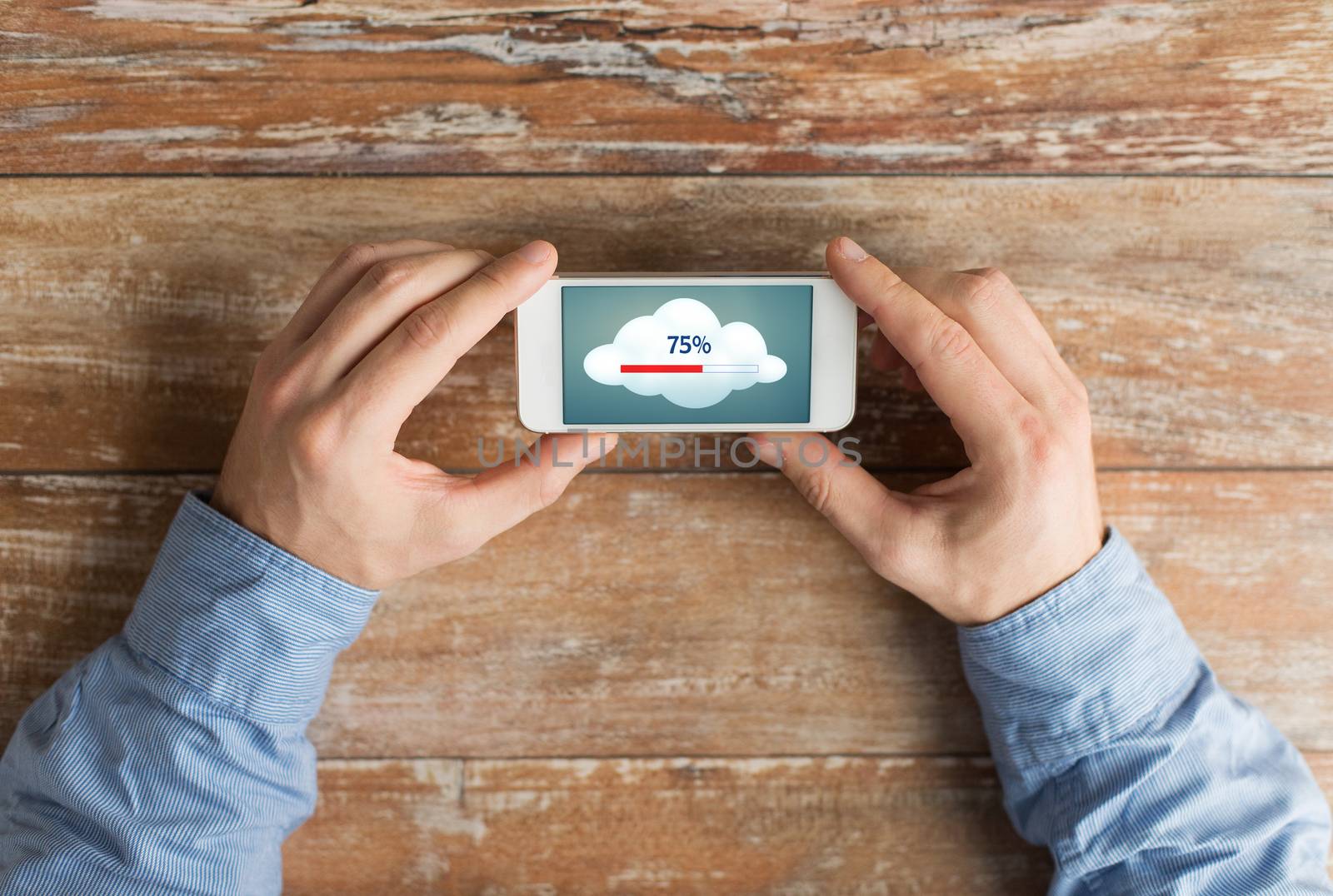 close up of hands with smartphone cloud computing by dolgachov