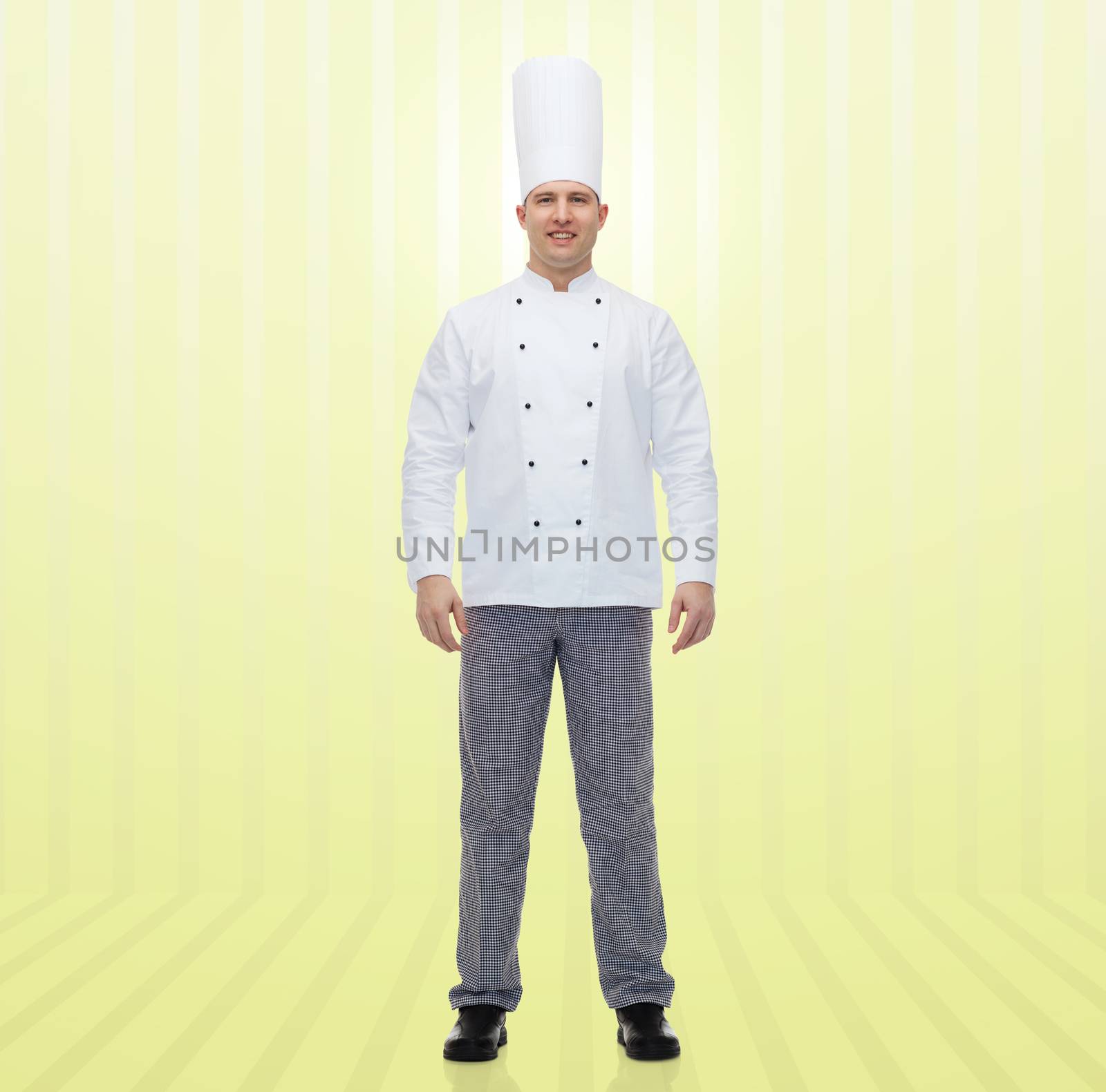 cooking, profession and people concept - happy male chef cook over yellow background