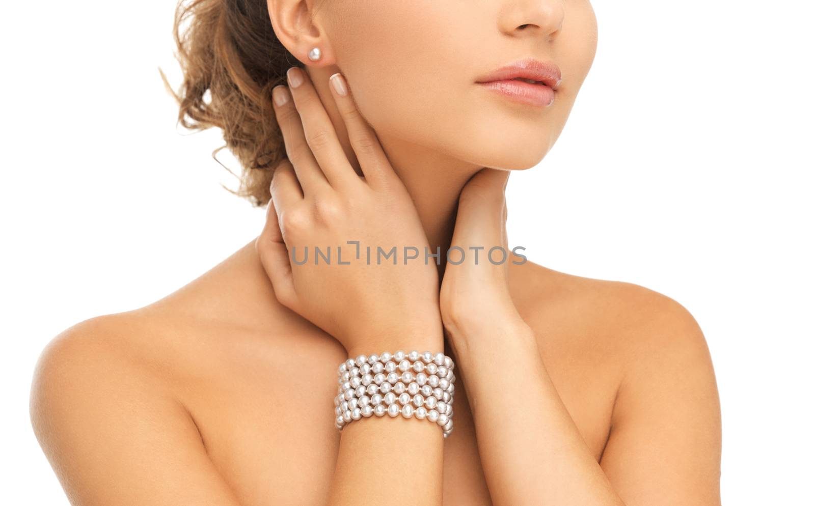 beautiful woman with pearl earrings and bracelet by dolgachov