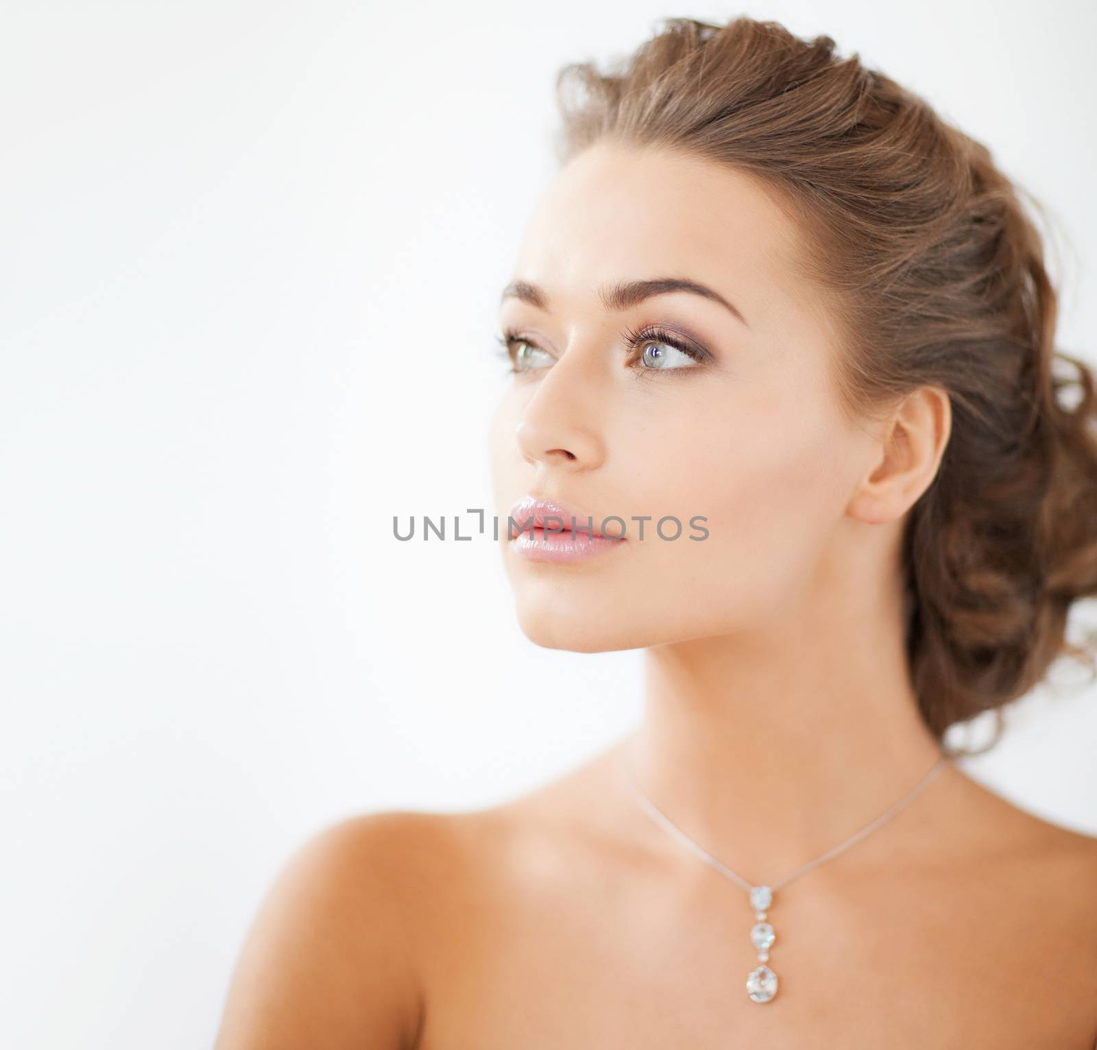 close up of beautiful woman wearing shiny diamond necklace