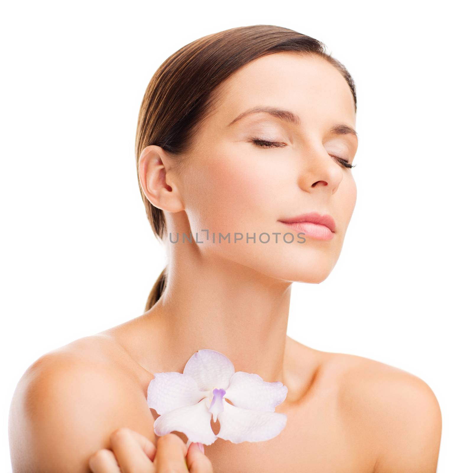 health and beauty concept - relaxed woman with orhid flower