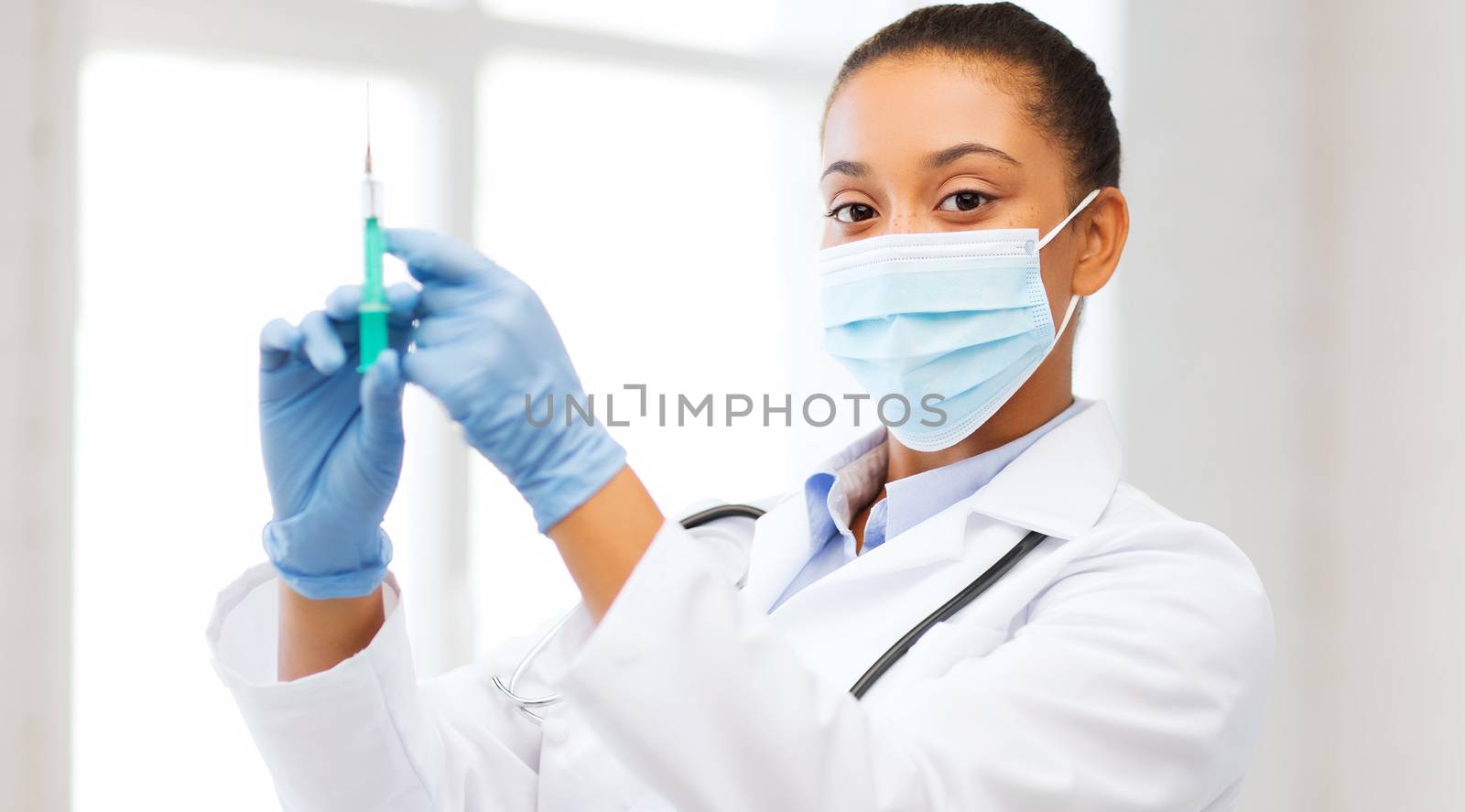 african doctor holding syringe with injection by dolgachov