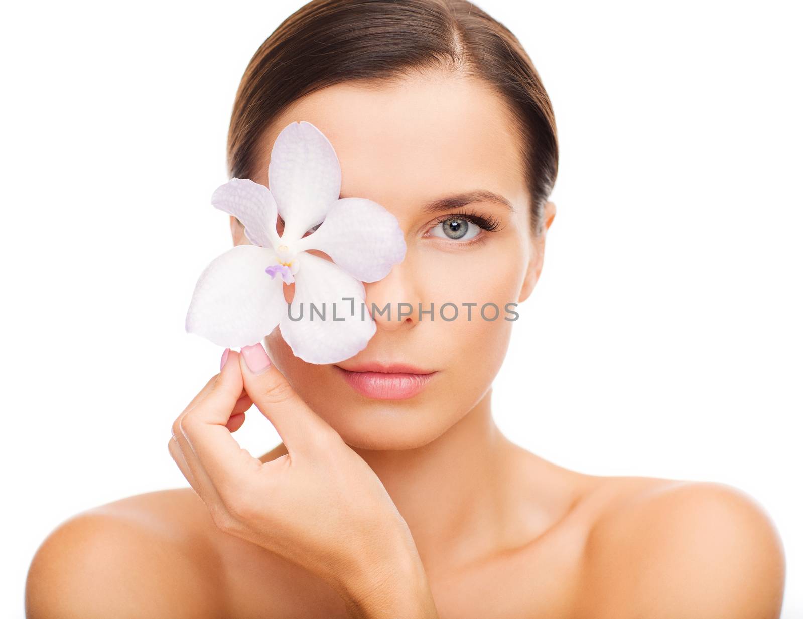 health and beauty concept - relaxed woman with orchid flower over eye