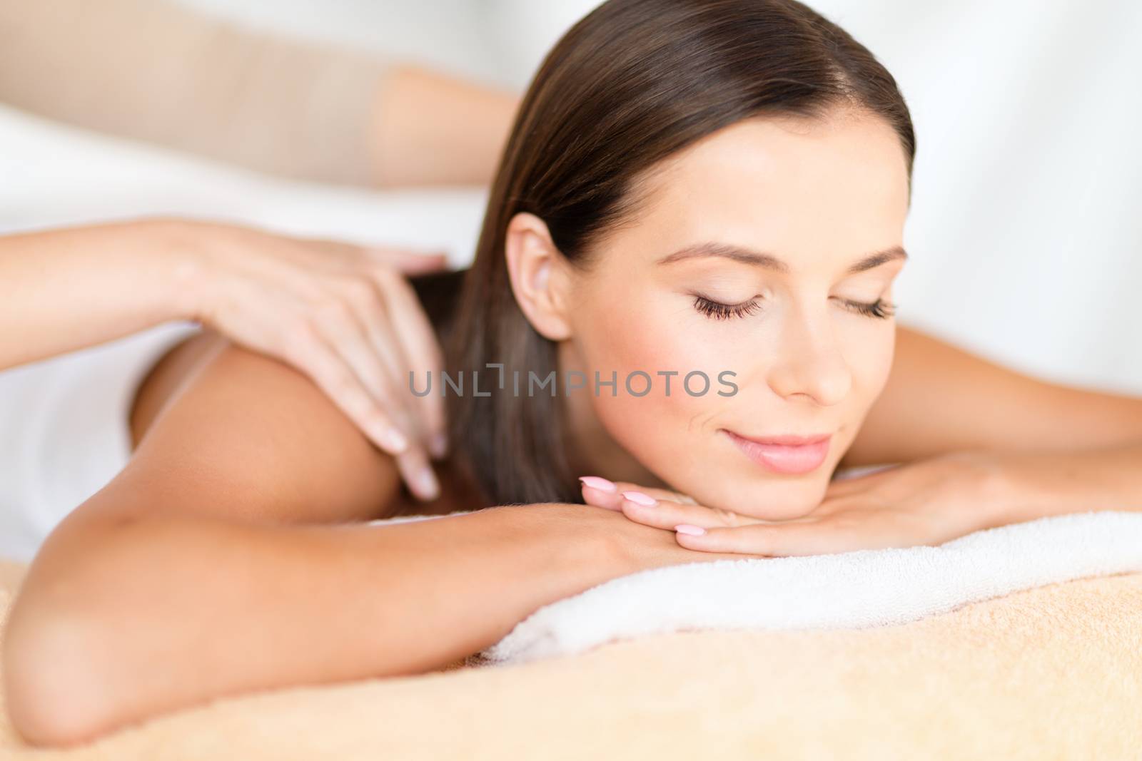 beautiful woman in spa salon getting massage by dolgachov