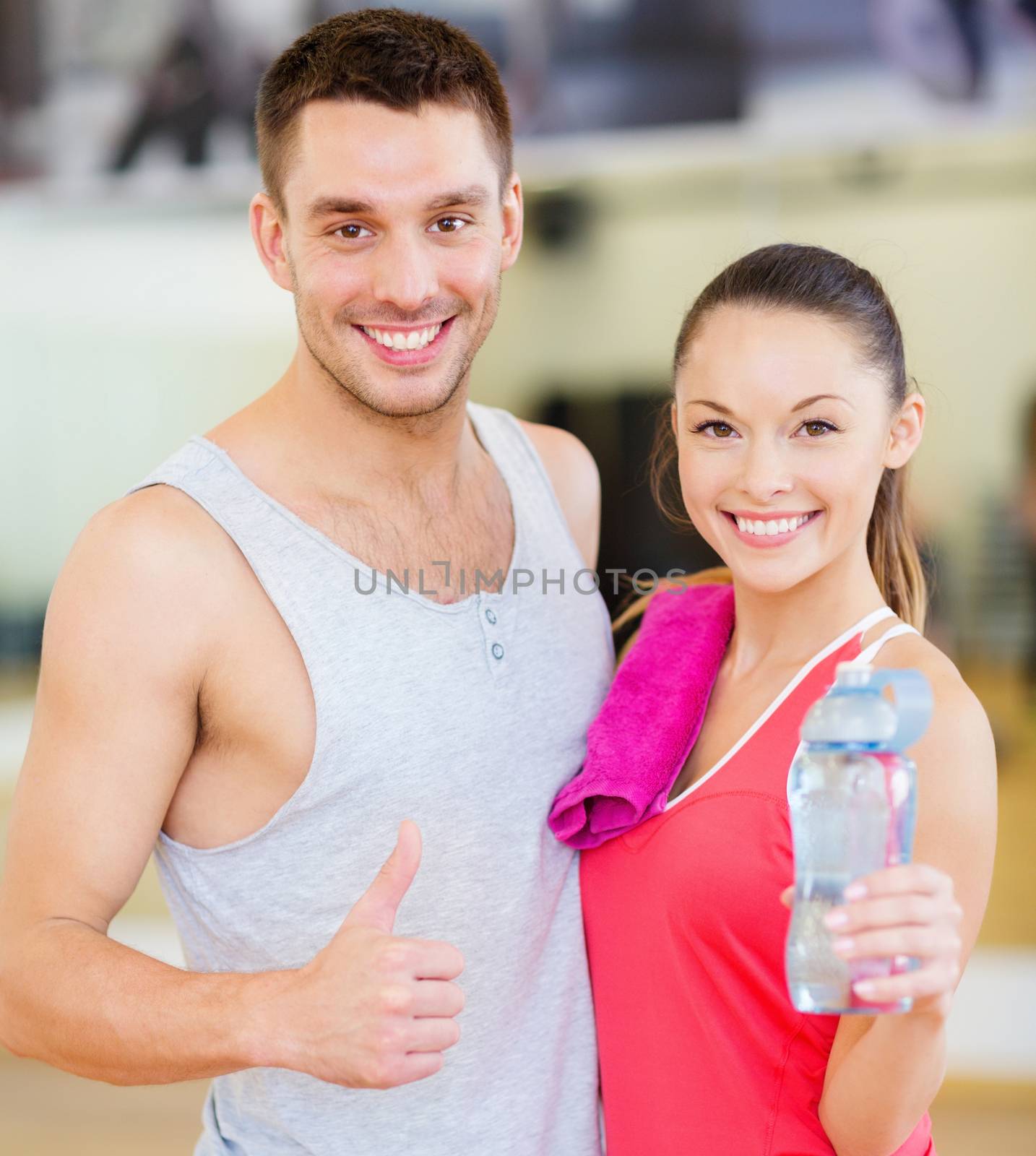 two smiling people in the gym by dolgachov
