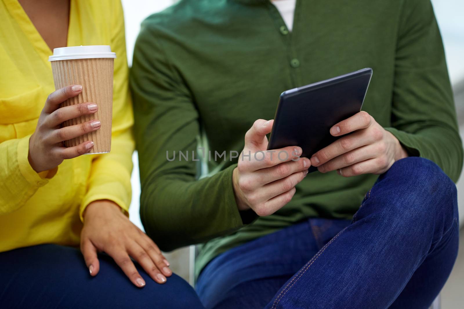 close up of students with tablet pc and coffee by dolgachov