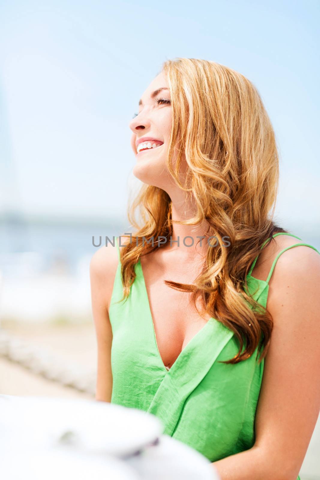 girl in cafe on the beach by dolgachov