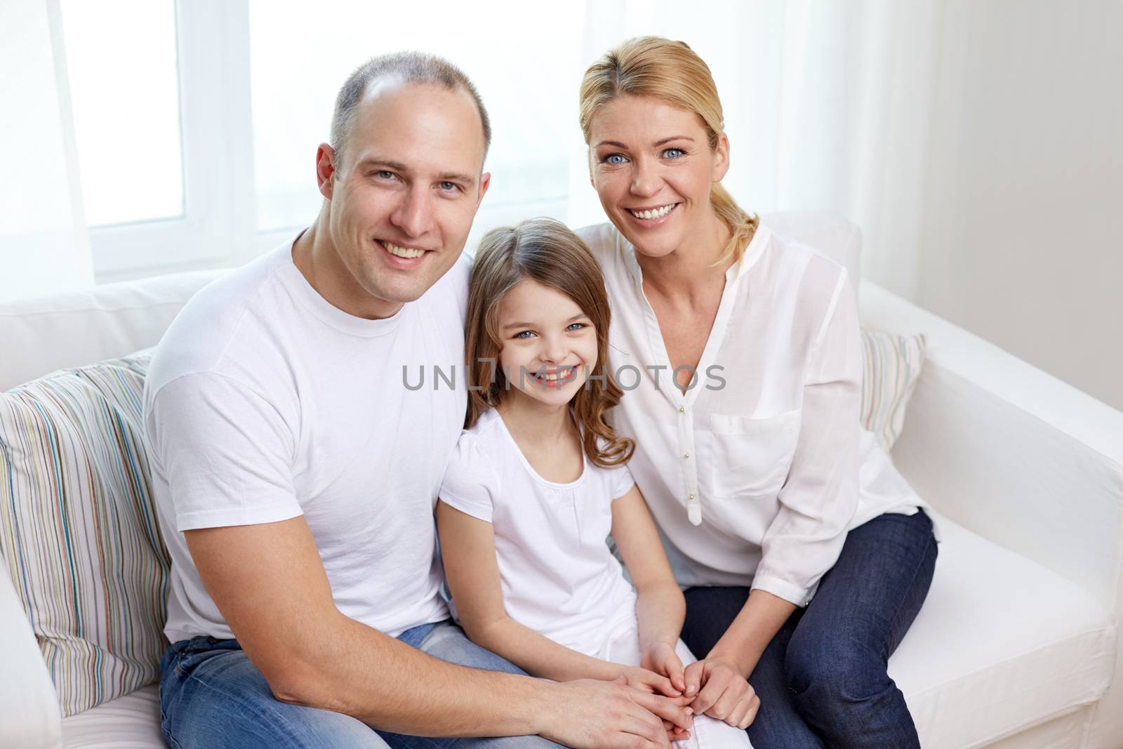 family, children and people concept - happy parents with little daughter at home