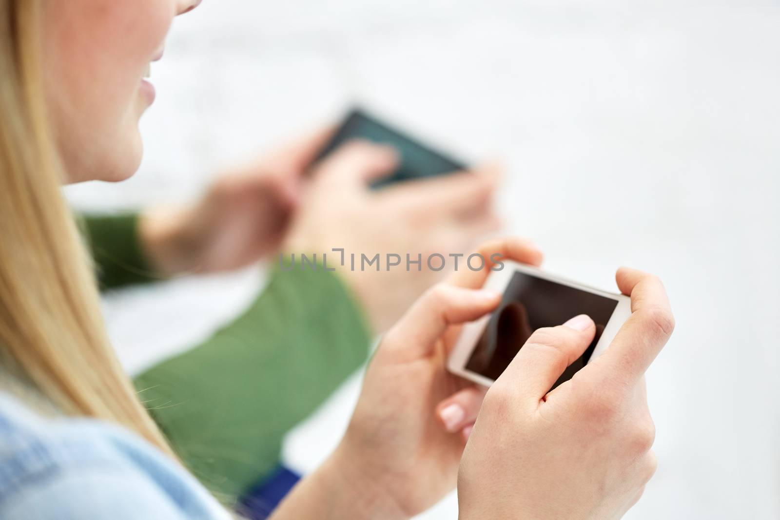 close up of female hands with smartphone by dolgachov