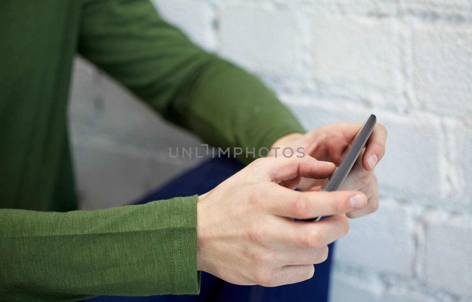 close up of male hands with smartphone by dolgachov