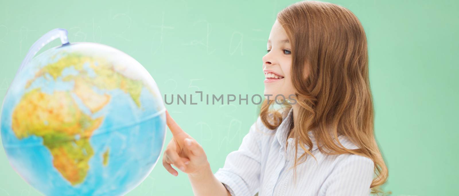 education, school, people, childhood and school concept - smiling little student girl with globe over green chalk board background