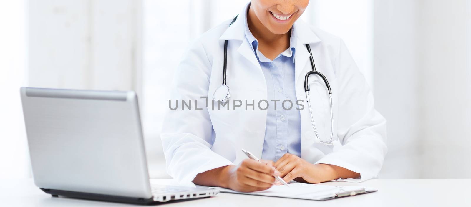 female doctor with laptop pc by dolgachov