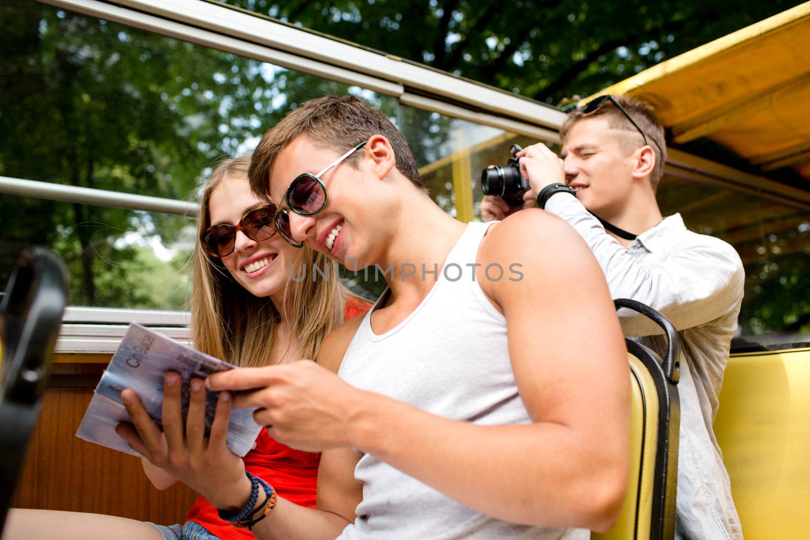 smiling couple with book traveling by tour bus by dolgachov