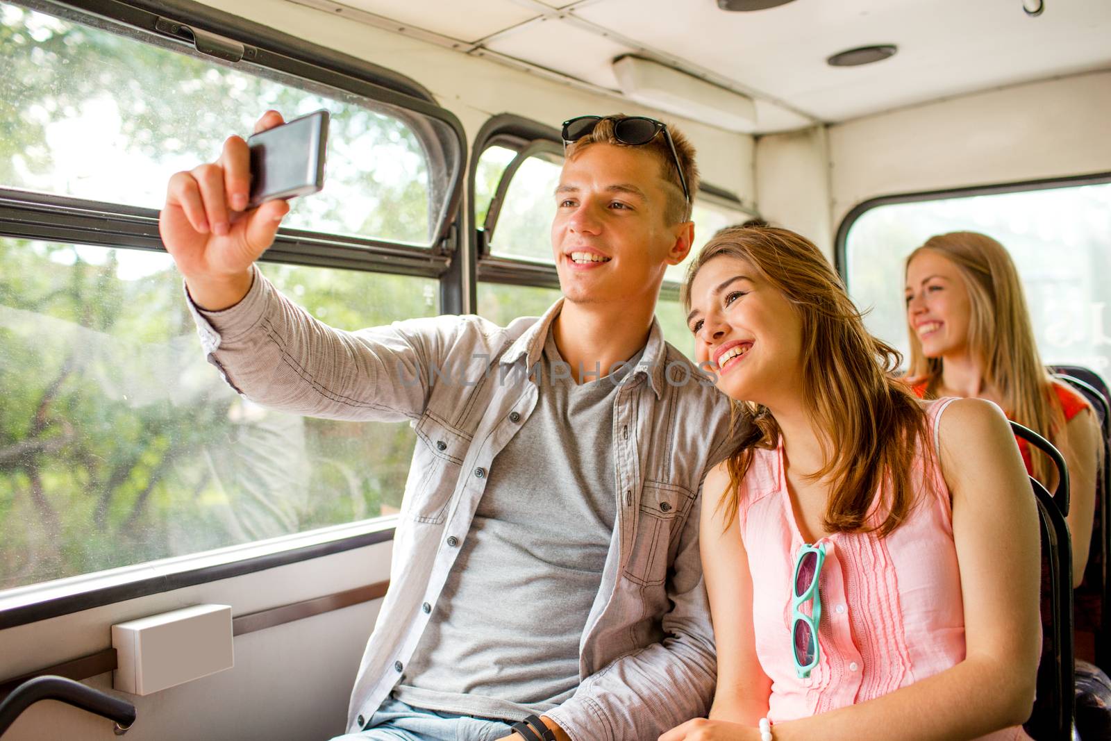 smiling couple with smartphone making selfie by dolgachov