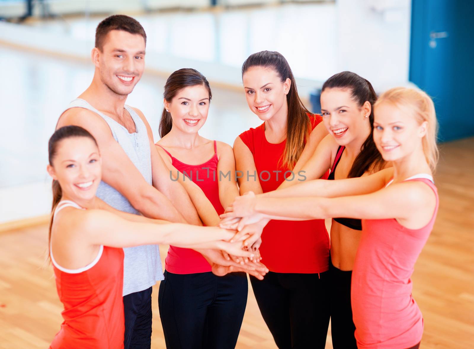 fitness, sport, training, success and lifestyle concept - group of happy people in the gym celebrating victory