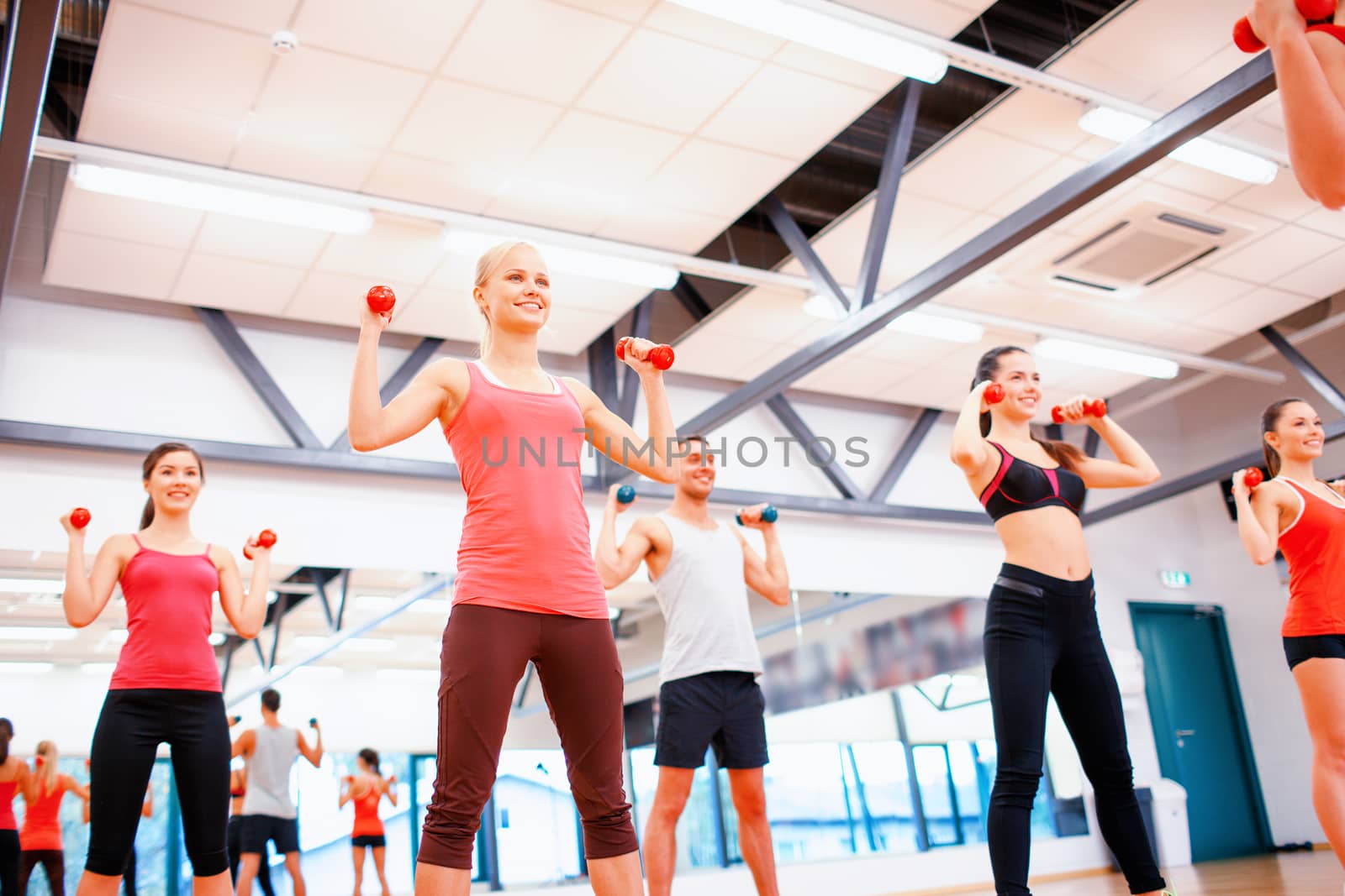 group of people working out with dumbbells by dolgachov