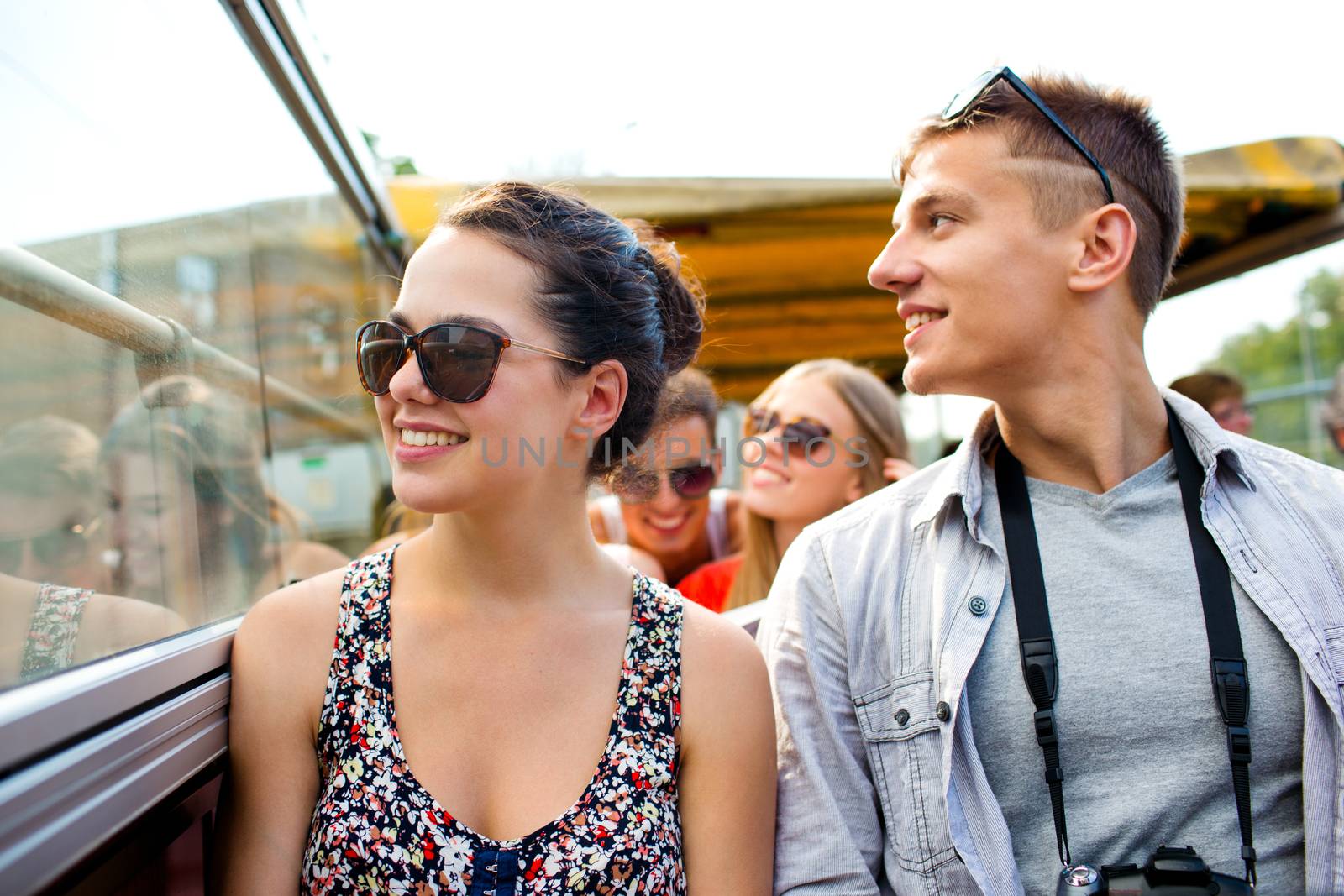 smiling couple with camera traveling by tour bus by dolgachov