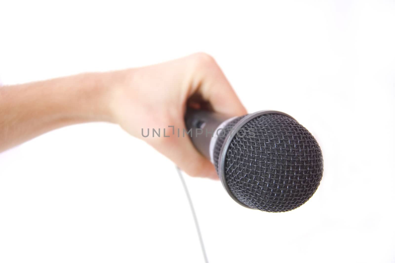 Microphone conceptual image. Hand holding a microphone